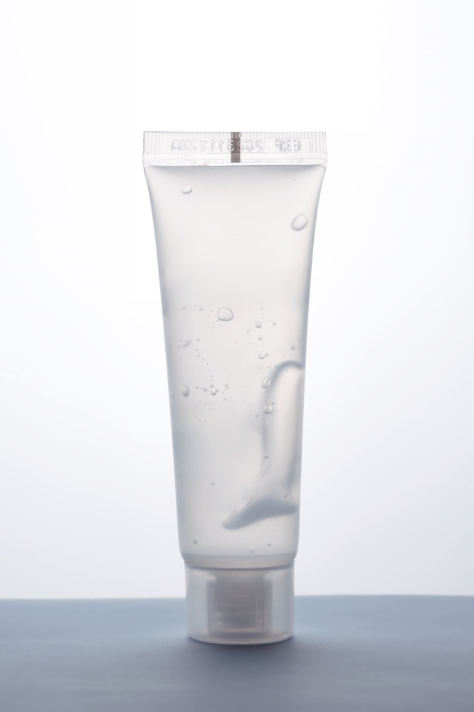 Transparent bottle of cosmetic gel on a white background. Suitable for advertising shower gel, shampoo and other care products.. Transparent bottle of cosmetic gel on a white background.