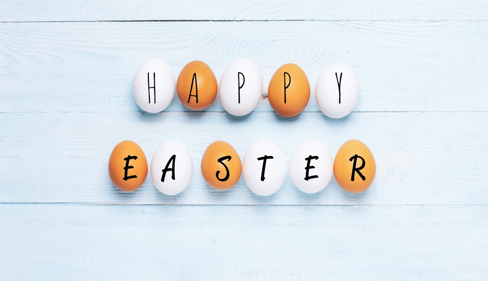 Festive composition Easter eggs with Phrase Happy Easter, pastel background. Festive flat lay concept Happy Easter. Festive composition Easter eggs with Phrase Happy Easter pastel background concept Easter