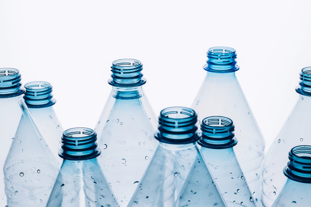 Empty plastic bottles on a blue background. Recycling recyclable plastic. Environment protection. Flat lay top view. Empty plastic bottles on a blue background. Recycling recyclable plastic. Environment protection