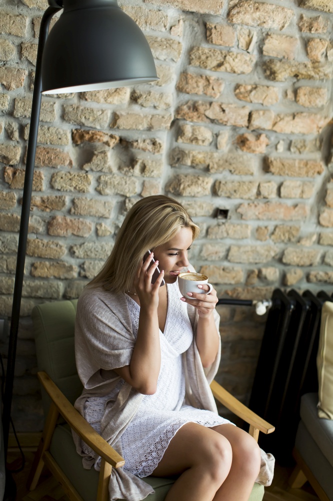 Young woman in cafe with mobile phone