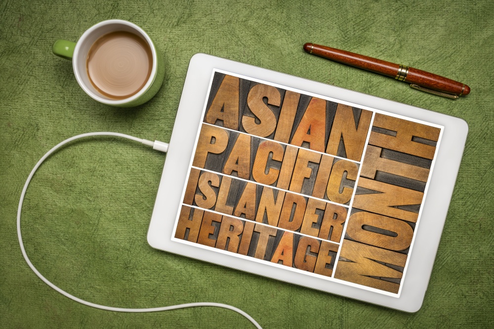 Asian Pacific Islander Heritage Month - word abstract in vintage letterpress wood type on a digital tablet, flat lay with coffee, reminder of cultural event