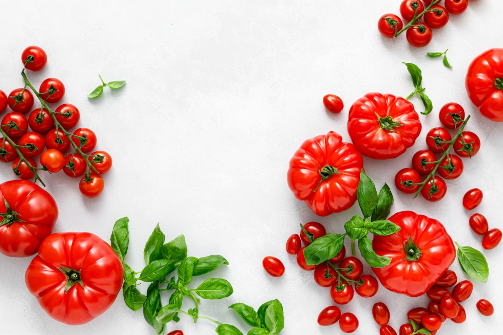 Tomatoes and basil on white background, top view, flat lay
