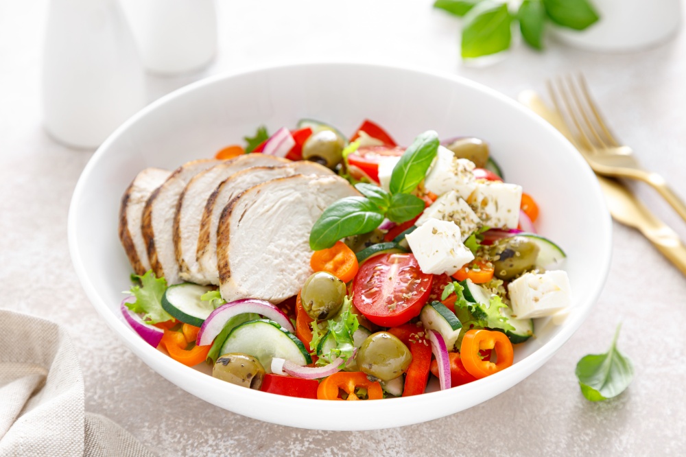 Grilled chicken breast and fresh greek salad with feta cheese