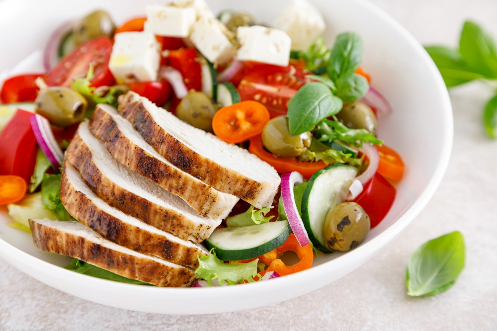Grilled chicken breast and fresh greek salad with feta cheese