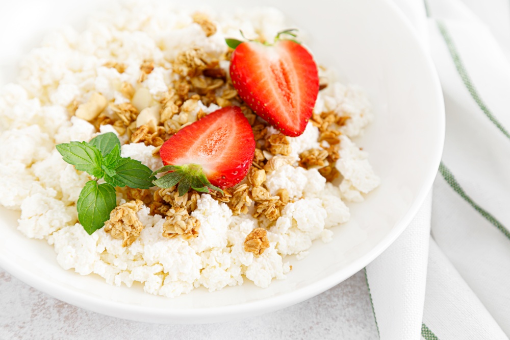 Cheese cottage, curd cheese with granola and fresh strawberry. Breakfast. Healthy food, diet