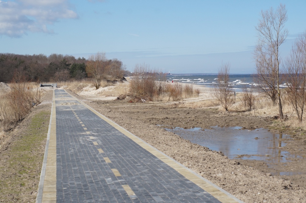 Bicycle lane along the sea. Construction of a bicycle lane. Unfinished pedestrian road. New bicycle lane made of sidewalk tiles.. Construction of a bicycle lane. Bicycle lane along the sea. Unfinished pedestrian road. New bicycle lane made of sidewalk tiles.