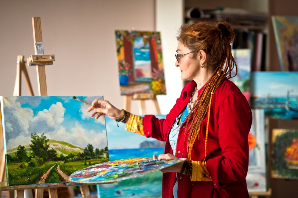 The process of painting an oil painting.. The artist paints an oil painting in her studio 2917.