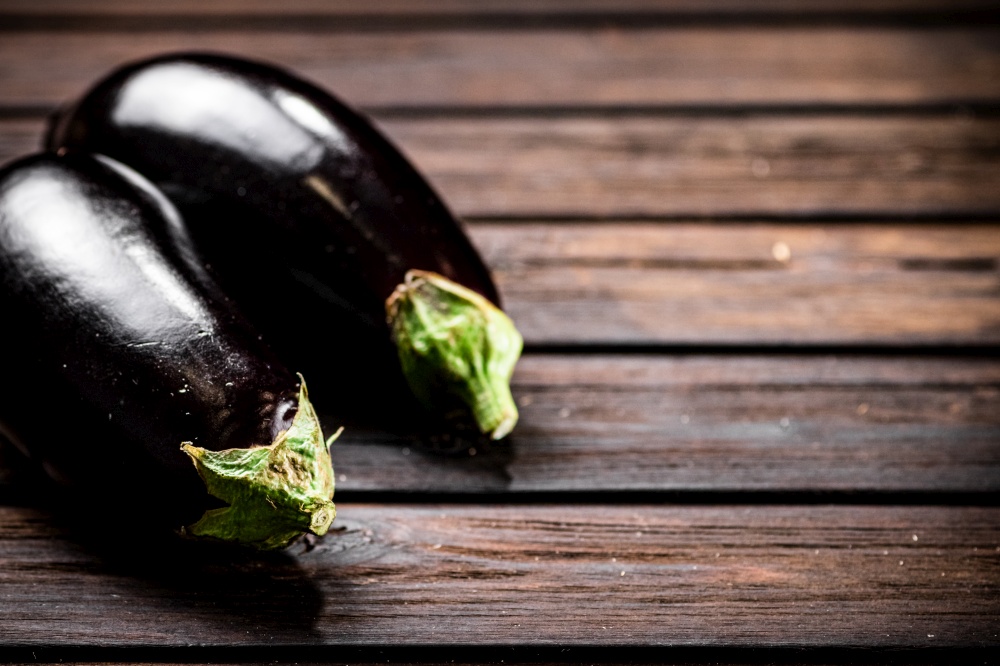 Fresh homemade eggplant on the table. On a wooden background. High quality photo. Fresh homemade eggplant on the table.