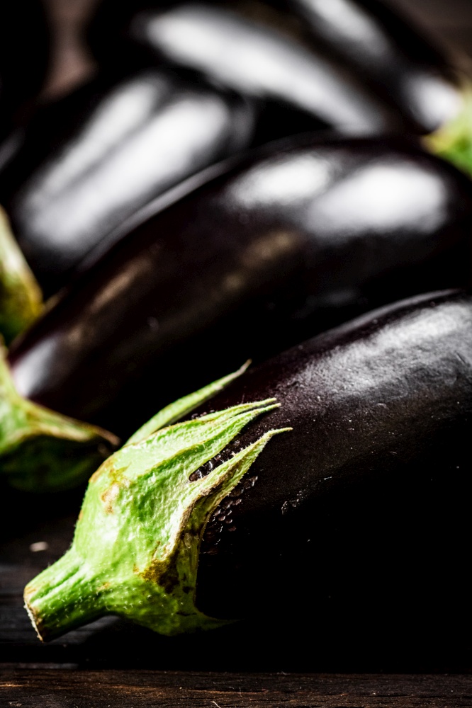 Fresh homemade eggplant on the table. On a wooden background. High quality photo. Fresh homemade eggplant on the table.