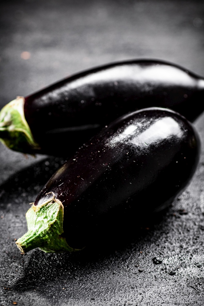 Fresh homemade eggplant on the table. On a black background. High quality photo. Fresh homemade eggplant on the table.