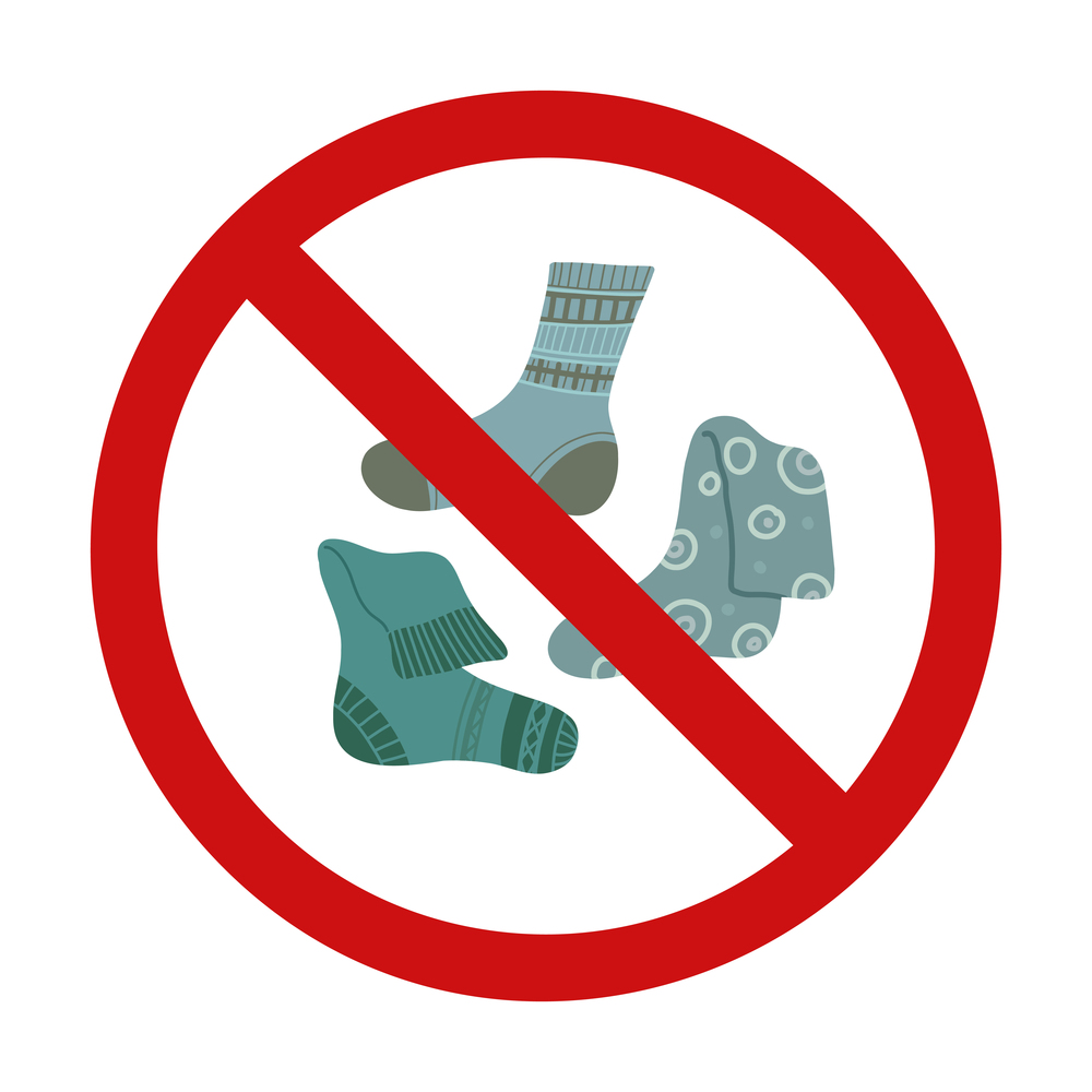 Vector prohibition sign with socks. Warning sign to clean up dirty clothes. Red forbidden sign with cartoon clothes for stickers.. Vector prohibition sign with socks. Warning sign to clean up dirty clothes. Red forbidden sign