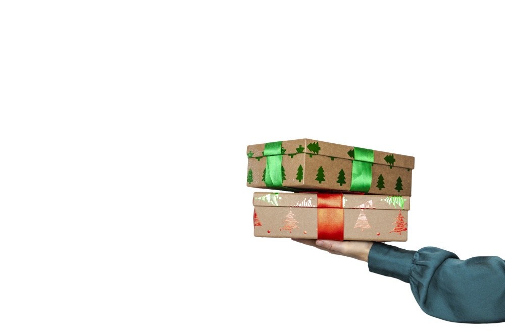 Woman hand holding a stack of Christmas gifts with red bow and isolated on white background With clipping path included. copy space Holiday concept space for text. Woman hand holding a stack of Christmas gifts with red bow and isolated on white background With clipping path included. copy space Holiday concept