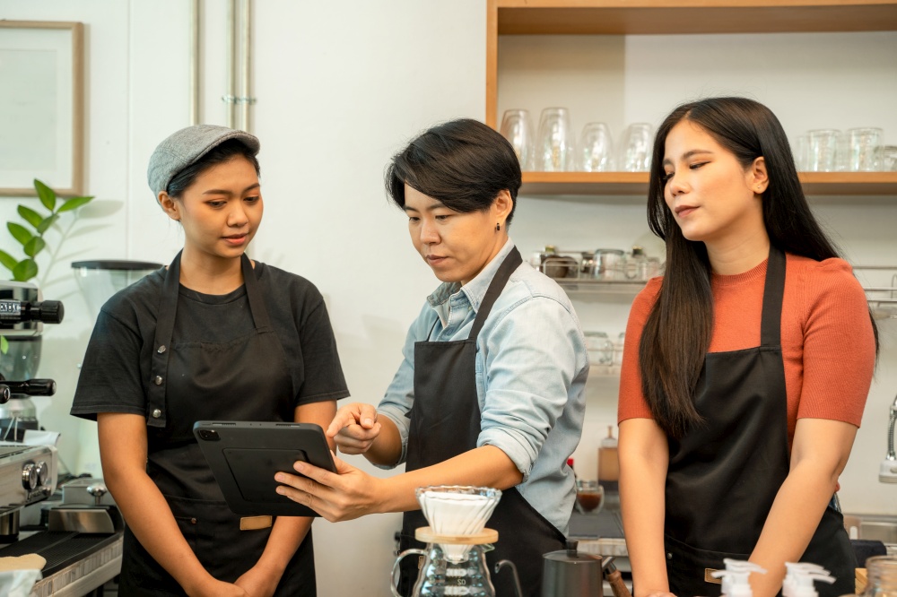 Young owner or barista wearing aprons working at the counter in coffee shop,Start up small business owner food and drink concept.