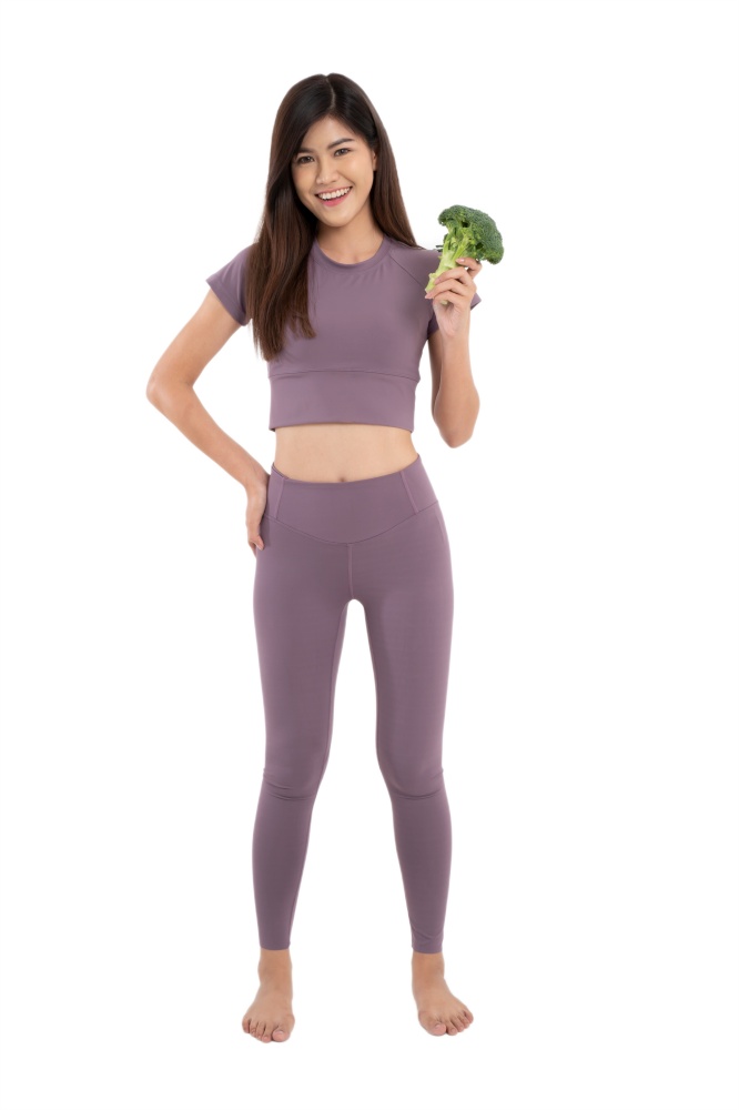 Portrait of young happy and healthy Asian woman holding Block Curry and looking at camera on white Isolated background. Concept of vegetarian diet, healthy lifestyle with healthy food.
