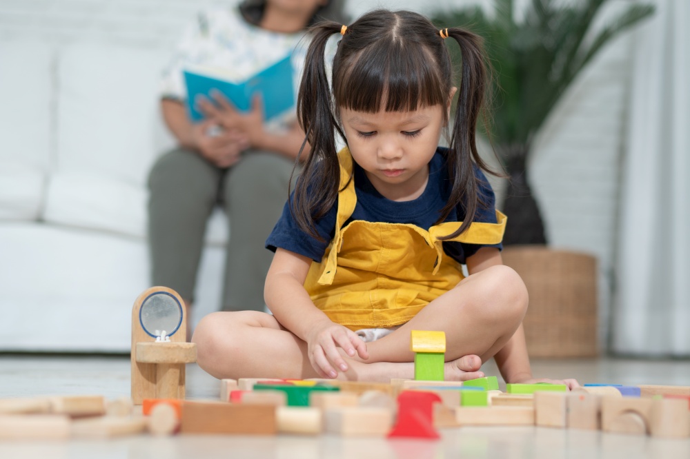 Cute asian little girl playing with colorful toy blocks, Kids play with educational toys at kindergarten or daycare. Creative playing of kid development concept, Toddler kid in nursery.