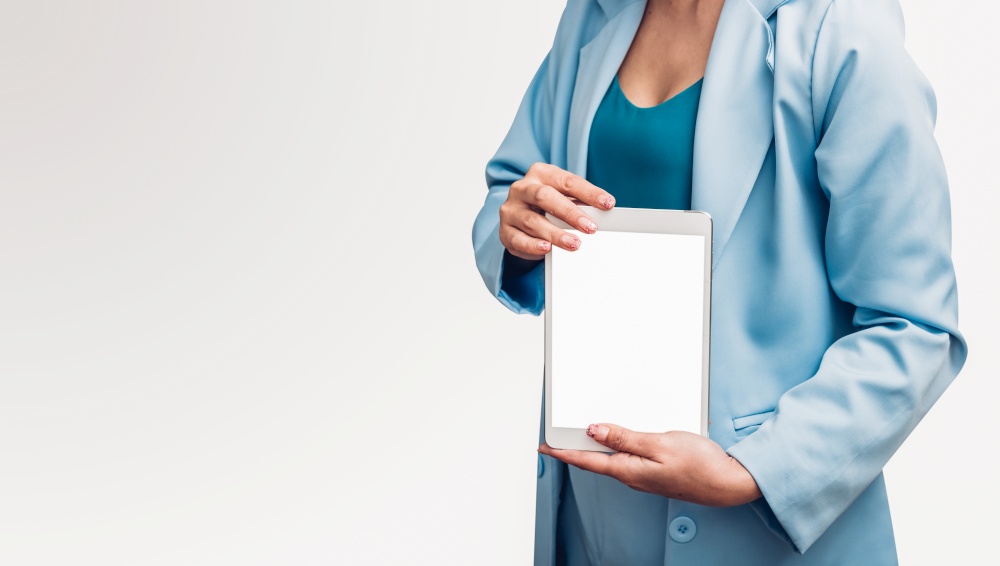 Young business woman holding and show screen digital technology tablet computer on her hand isolated white background
