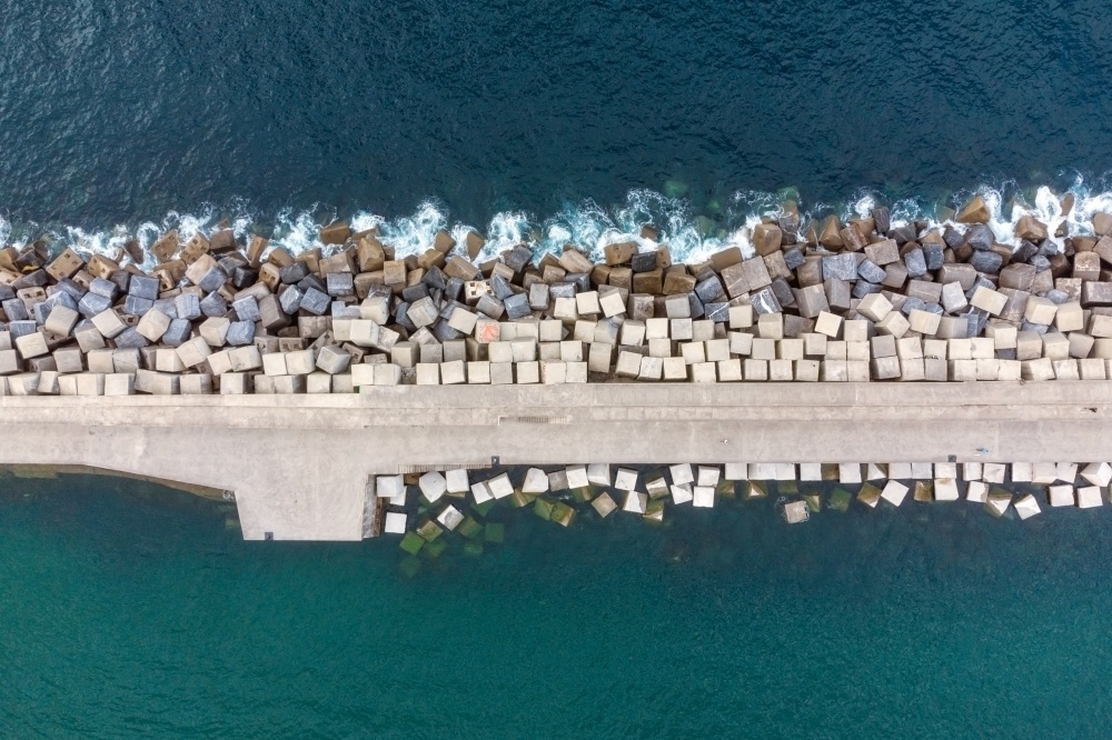 Aerial Drone Flying, Breakwater Of Stone In The Sea. High quality photo. . Aerial Drone Flying, Breakwater Of Stone In The Sea.