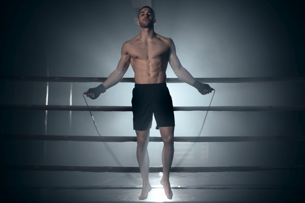 Boxer jumping rope in boxing ring. High quality photo. Boxer jumping rope in boxing ring.