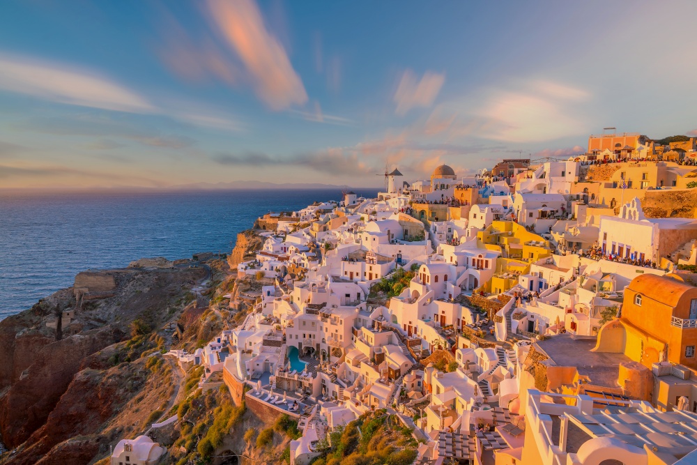 Cityscape of Oia town in Santorini island, Greece. Panoramic view at the sunset.