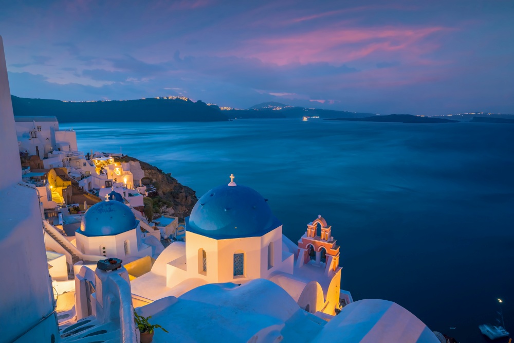 Cityscape of Oia town in Santorini island, Greece. Panoramic view at the sunset.