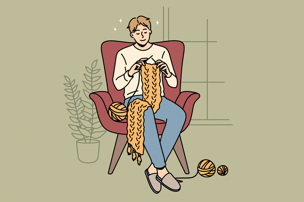 Home hobbies and knitting concept. Young smiling man cartoon character sitting at home in armchair knitting scarf vector illustration . Home hobbies and knitting concept