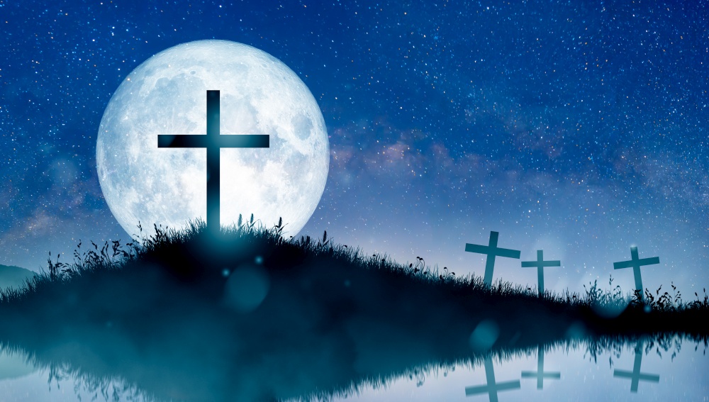 Christian cross on hill at night over the full moon. Crucifixion of Jesus Christ. Christmas, Easter, Salvation of sins, Sacrifice, and Religion Concept.