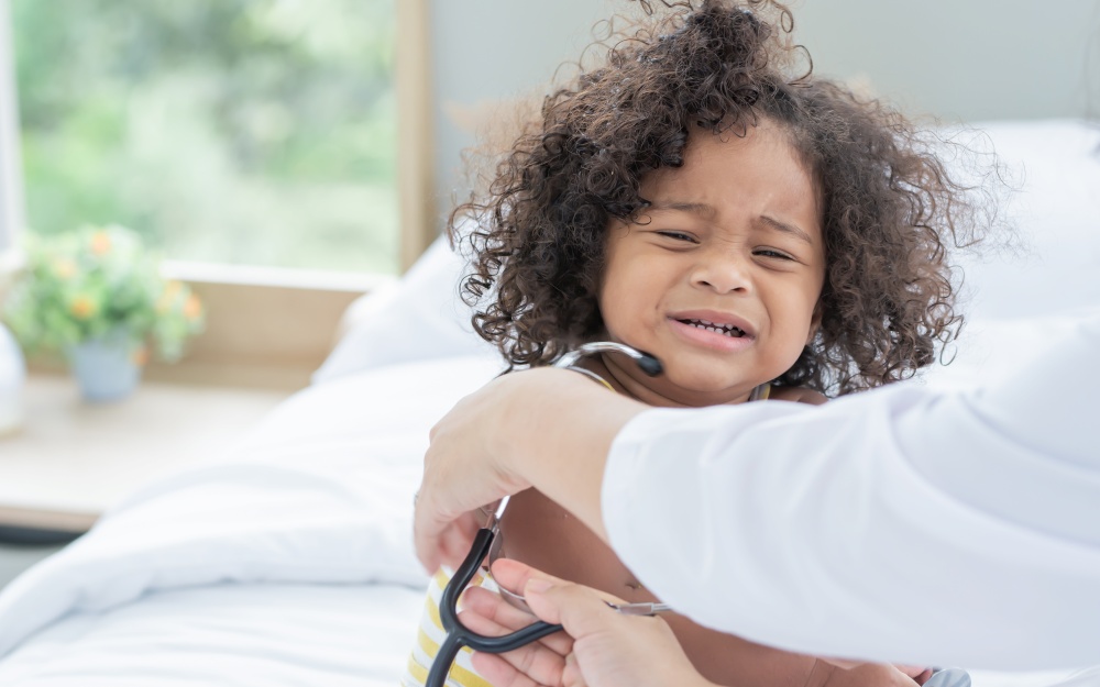 Portrait of African black little girl making funny face, wearing stethoscope and pretending to be a doctor and wearing stethoscope. Education Concept.
