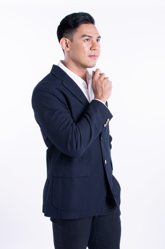 Portrait of successful asian young business man wearing formal suit and shirt, smiling with confidence and standing on white background.