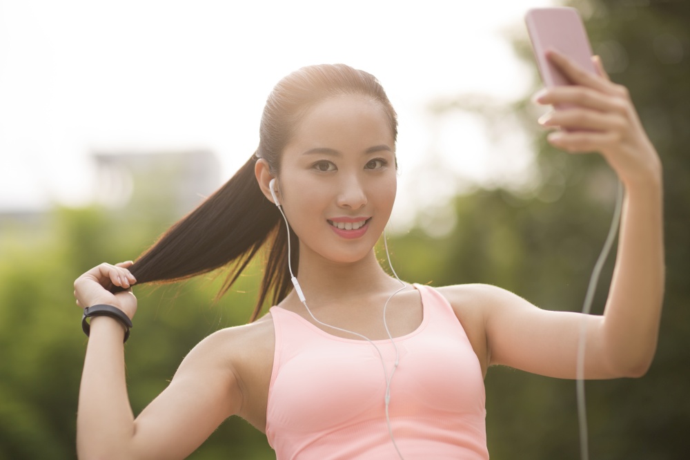 A fitness woman holding her phone