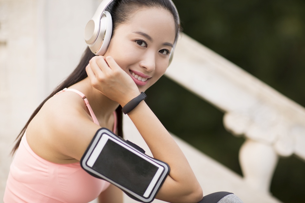 Energetic beauty listening to music for fitness