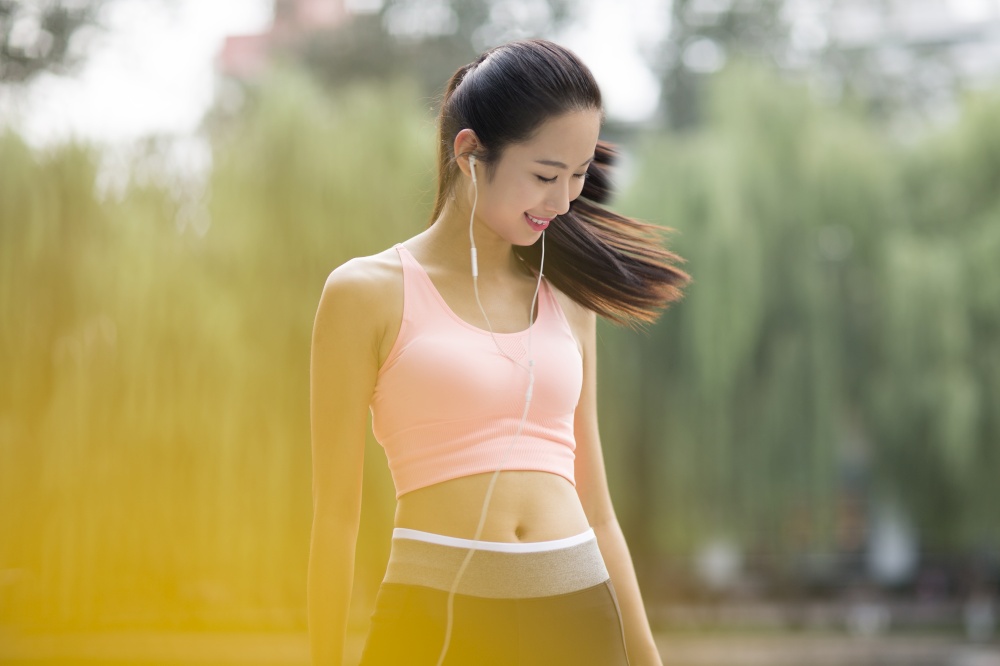 Woman in tracksuit listening to music