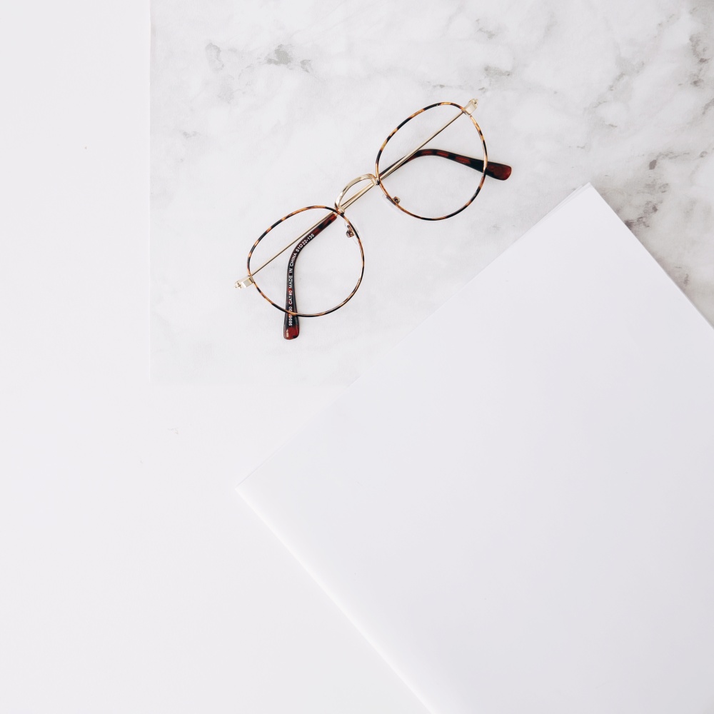 eyeglasses white paper textured white backdrop