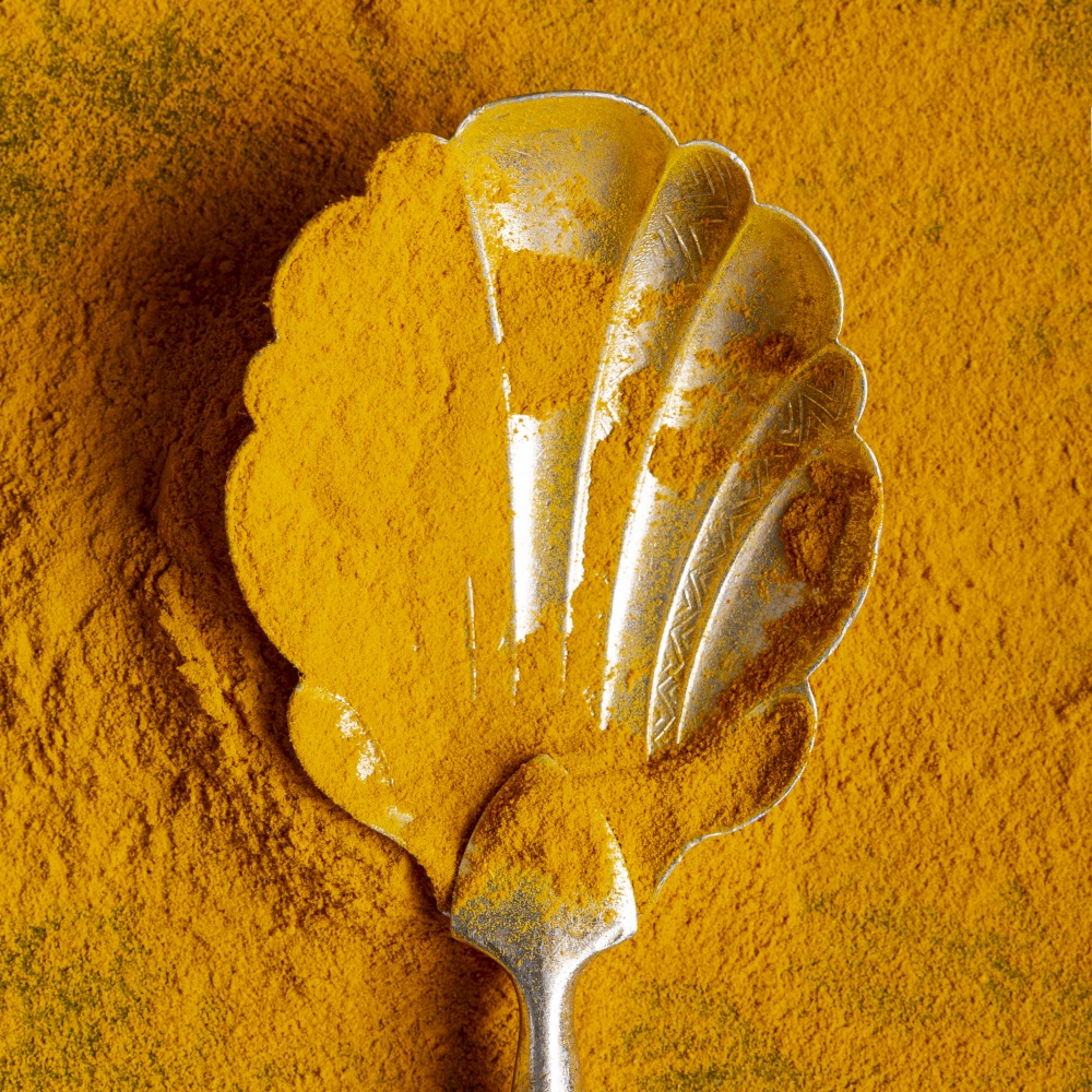 close up spoon with turmeric