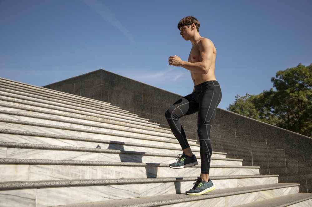 side view shirtless man exercising stairs outdoors