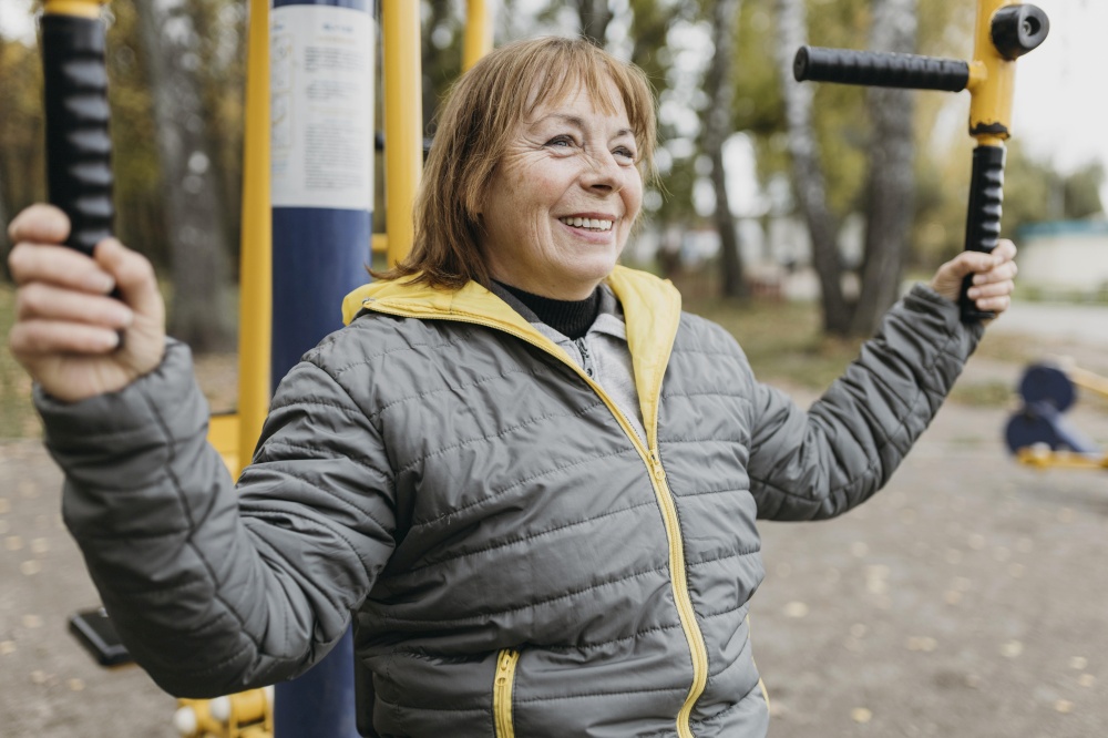 side view smiley older woman working out outdoors