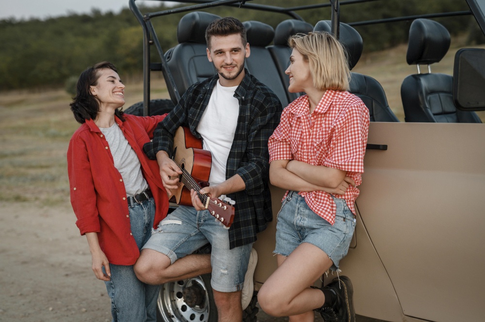 smiley friends playing guitar while traveling by car
