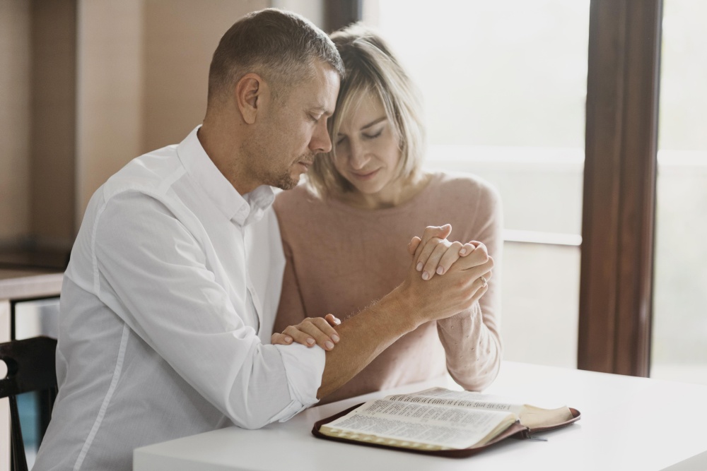 wife husband praying together home