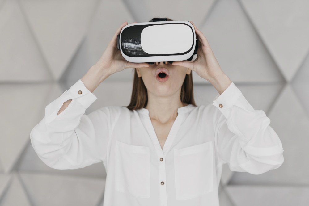 woman using virtual reality headset being amazed