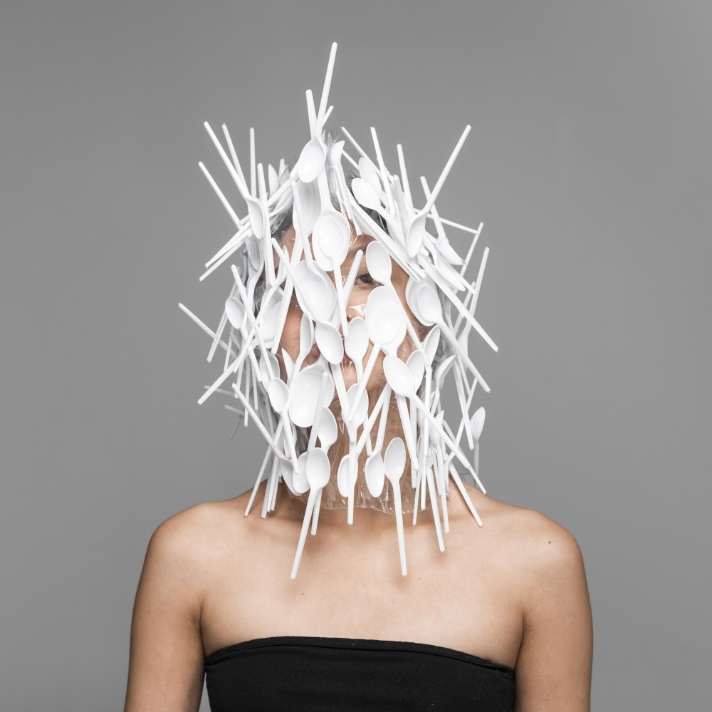 woman face being covered white plastic