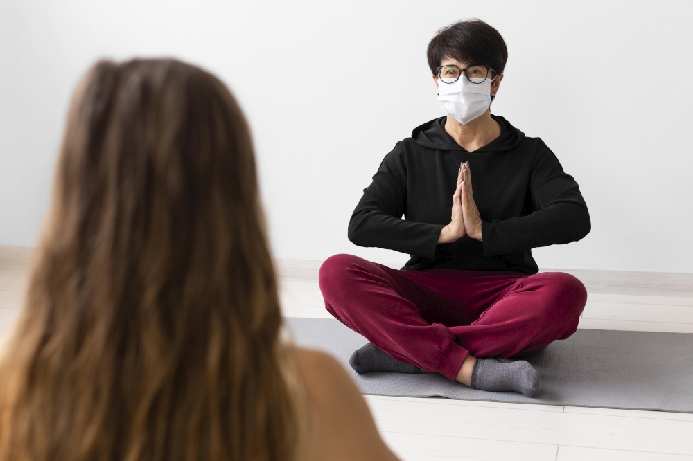 woman meditating with face mask 2