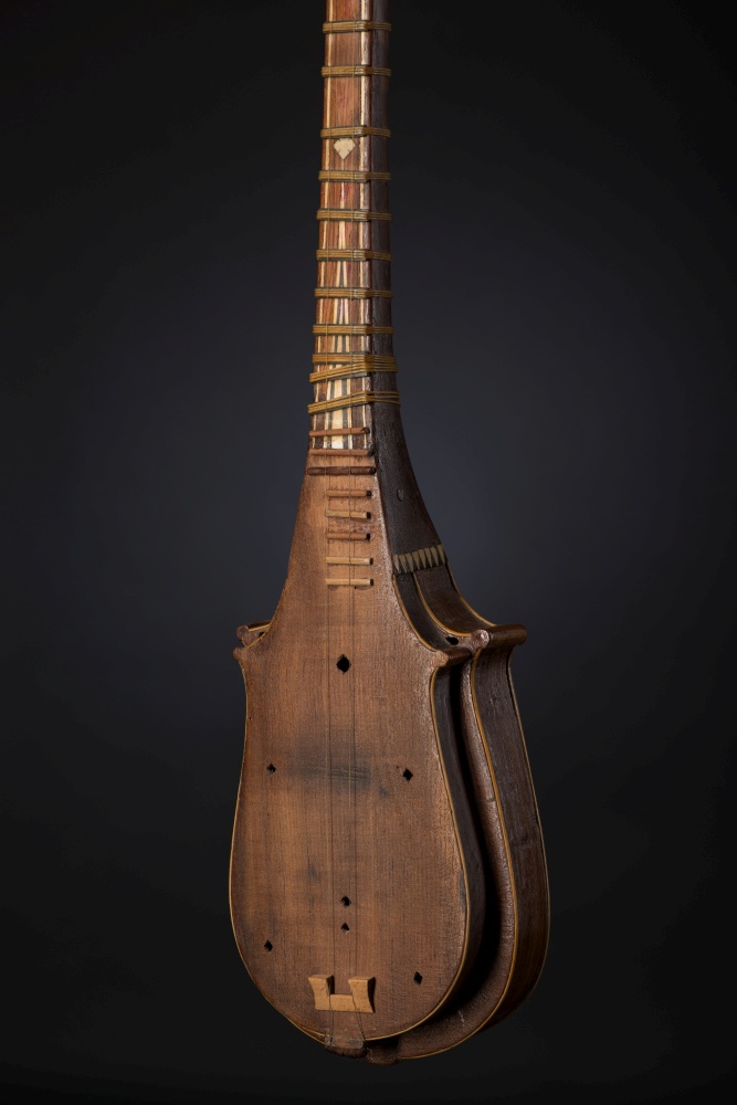 part ancient Asian stringed musical instrument on black background with backlight. national musical instrument of Asia