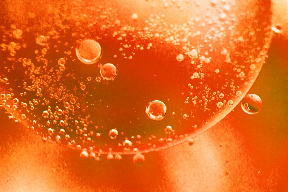 abstract light orange background with oil circles . bubbles of water close up . oil bubbles in the water macro. fiery circle bubbles background. abstract light orange background with oil circles . oil bubbles of water close up. fiery circle bubbles background