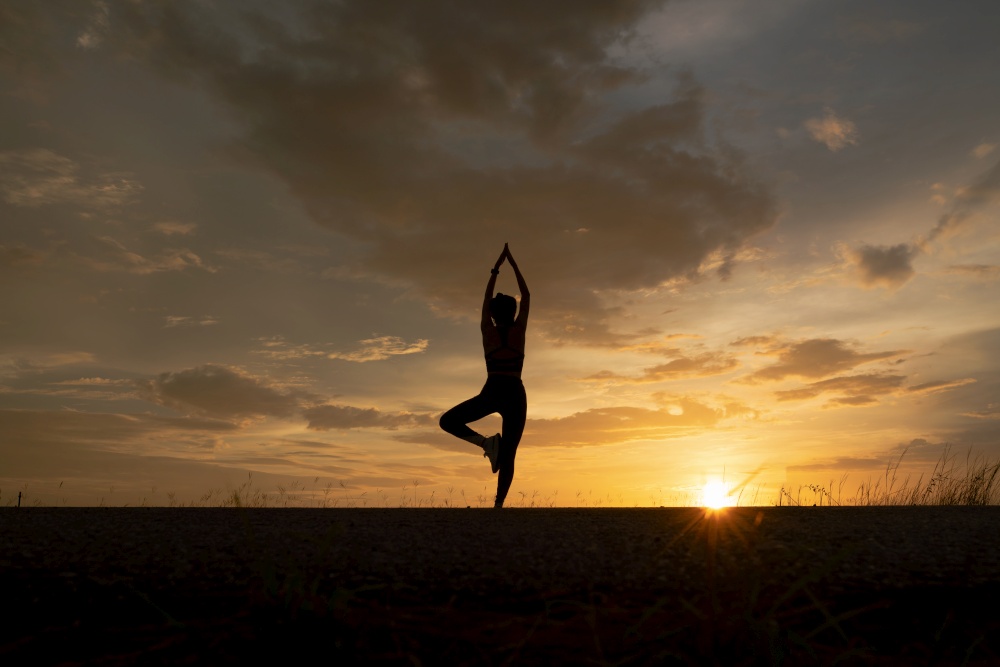 silhouette of women exercising with yoga poses