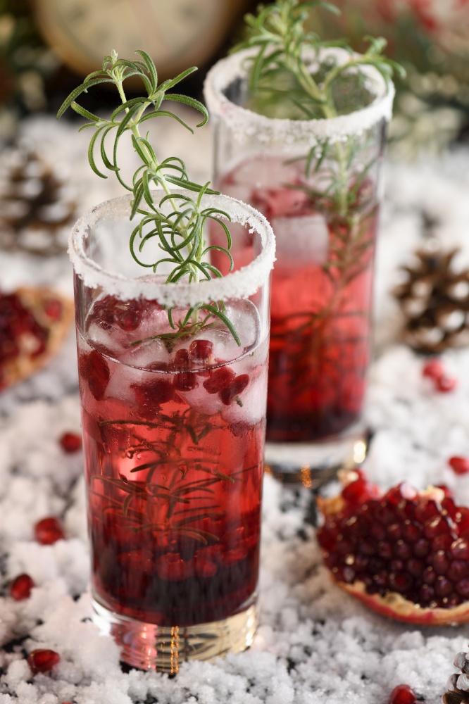 Glass with pomegranate Margarita with candied cranberries, rosemary. Perfect cocktail for a Christmas party