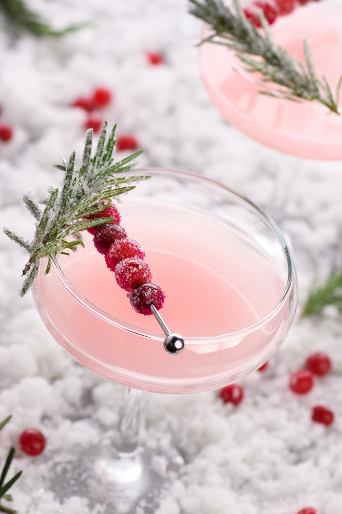 Goblet with cranberry Margarita with candied cranberries, rosemary. Perfect cocktail for a Christmas party