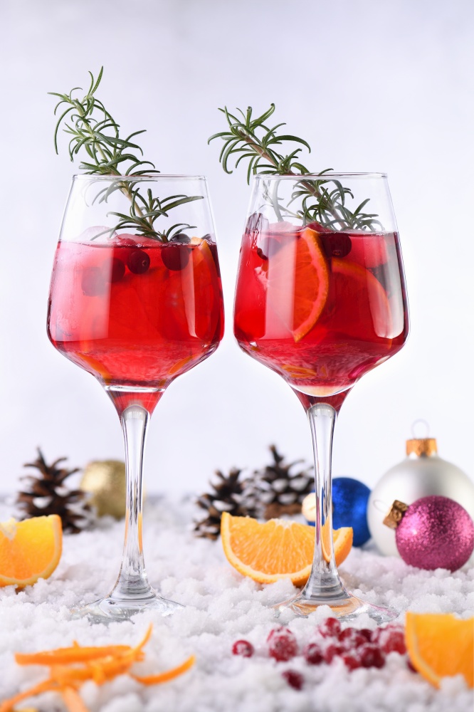 Cocktail Margarita with cranberries, orange and rosemary. A perfect cocktail for a Christmas party