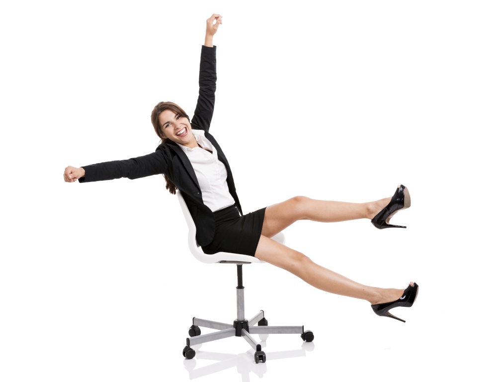 Happy business woman sitting on chair with arms up, isolated over white background