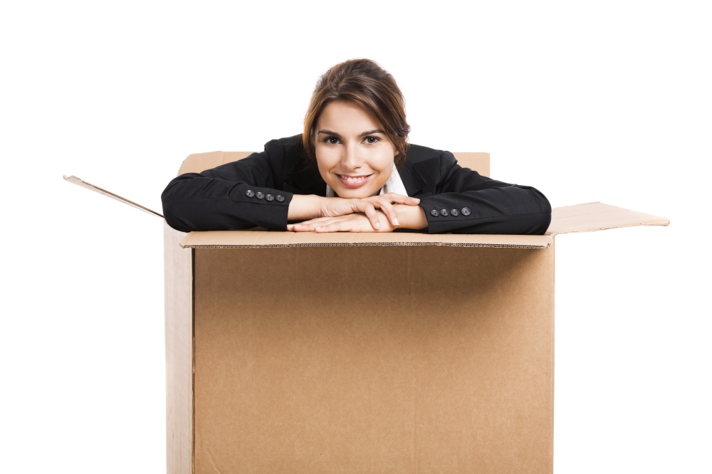 Happy business woman appear inside a big card box, isolated over white background . Inside the box
