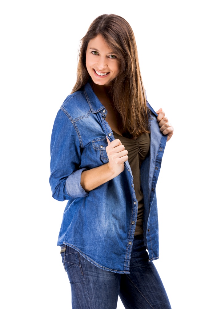 Beautiful woman over a white background holding her jeans shirt and smiling. Beautiful woman