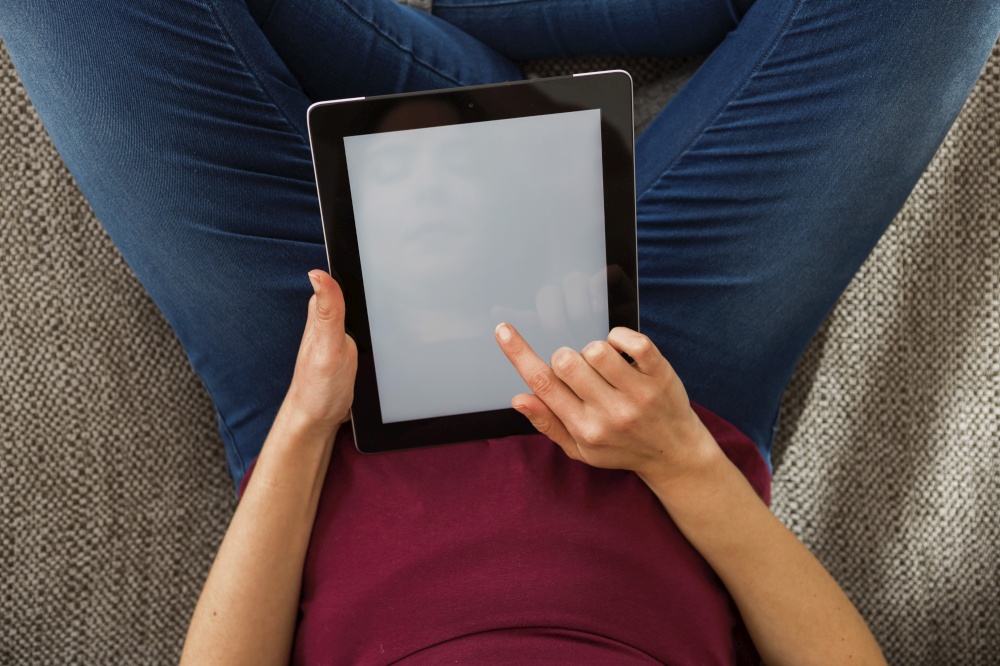 Cropped shot of female hands working with a tablet, tablet with copy space